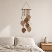 Macrame Leaf Wall Hanging, 25 x 60 cm, 2 Colors hung on the wall above a bed