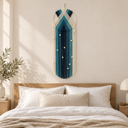 Chevron hoop wall hanging centered above a wooden bed headboard