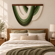 Green open fan wall hanging centered above a wooden bed headboard