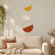 Woven wall art set of 3 hung above a cream sofa beside a trailing pothos plant