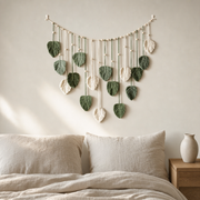 Woven Leaf Garland Wall Hanging, Green or Coffee hung on the wall above a bed