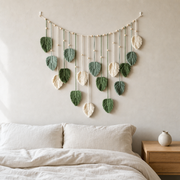 Macrame Leaf Garland Wall Hanging, 120 x 75 cm, 3 Colors hung on the wall above a bed