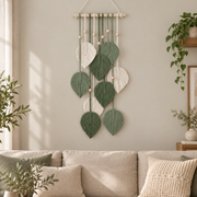 Living room above a sofa, macrame leaf cascade on a dowel, twisted cord, combed flat at the leaves, pale wooden dowel