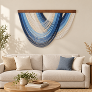 Living room above a cream sofa, graded swag fan in four colorways