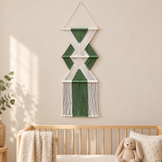 Nursery accent wall beside a cot, stacked hourglass tiers, twisted cord, short pale dowels