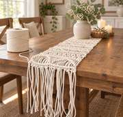 Finished macrame table runner on a dining table with a spool beside it