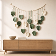 Woven Leaf Garland Wall Hanging, Green or Coffee hung on the wall above an oak sideboard