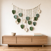 Macrame Leaf Garland Wall Hanging, 120 x 75 cm, 3 Colors hung on the wall above an oak sideboard