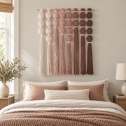 Bedroom above a dressed bed, wrapped sphere grid in blush, wrapped yarn spheres, white binding cord