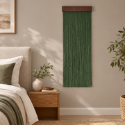 Fringe wall hanging on a bedroom wall beside a bed and wooden bedside table