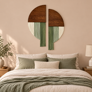 Two half disc wall pieces hung above a headboard with green bedding