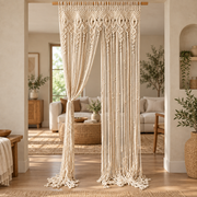 Macrame curtain dividing a living room, one side tied back to the frame
