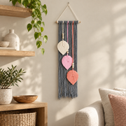 Living room beside a shelf with trailing plant, macrame leaf trio