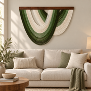 Green fan wall hanging above a cream three seat sofa in a living room