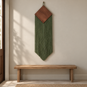 Quiet entry wall above a bench, wood diamond over a narrow chevron fringe