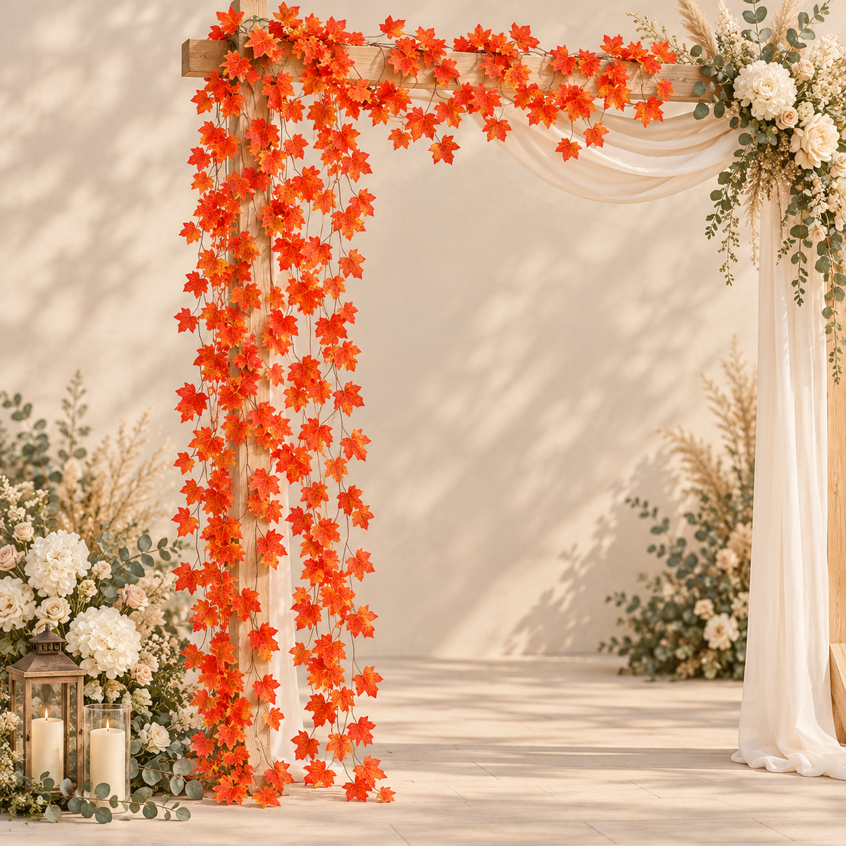 Fall leaf vine wrapped around a wedding arch with white drapery and florals