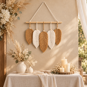Cream leaf cluster above a dressed wedding welcome table with candles