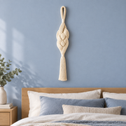 Bedroom on a blue wall beside a bed, braided rope wall pendant