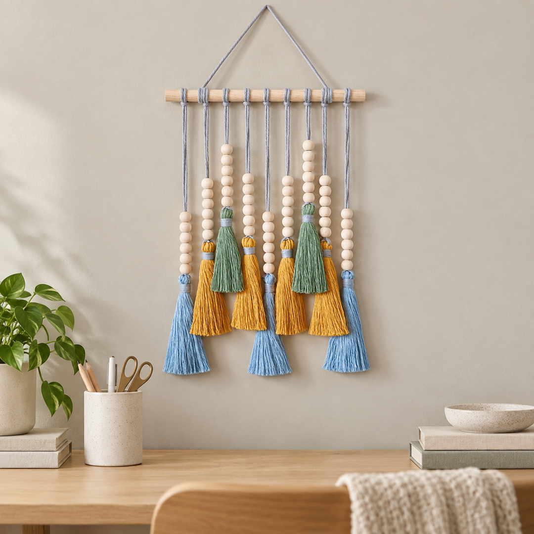 Creative desk wall above a pen pot, small beaded tassel row on a dowel