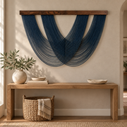 Indigo swag fan wall hanging above a long oak console in an entry hall