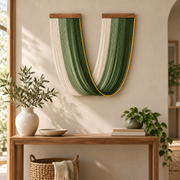 Green U swag wall hanging above a wooden console in an entry hall