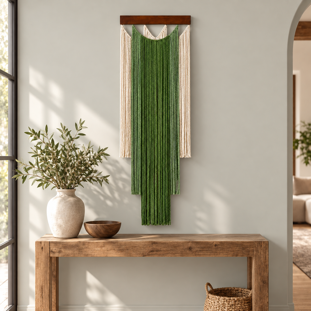 Green stepped fringe wall hanging above a rustic wooden entry console