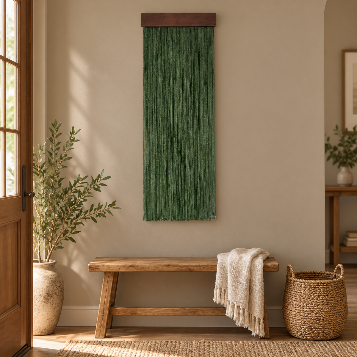 Green fringe wall hanging above a rustic bench and basket in an entry hall