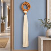 Hotel hallway on a blue wall, terracotta ring and long tassel
