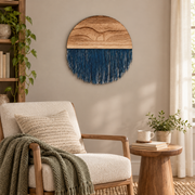 Round woven wall decor above a boucle armchair in a living room reading nook