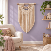 Macrame wall hanging on a lilac nursery wall beside a boucle chair and toys