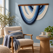 Blue nested arc wall hanging above a wooden armchair in a reading corner