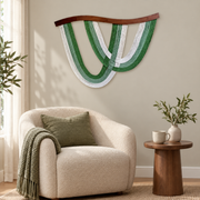 Looped rope arc wall decor above a boucle armchair in a reading corner