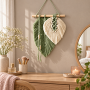 Leaf wall hanging above a vanity dresser beside a round mirror and candle