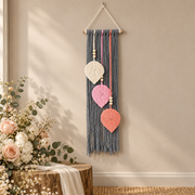 Wedding welcome wall with a floral arrangement, macrame leaf trio