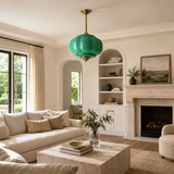 Living room with beige sofa, coffee table, and green pendant light.
