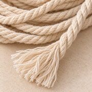 Macro of the three-strand twist and a combed cut end, 2 to 10 mm twisted cord on a spool