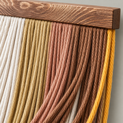Close view of multi color cord and the fine gold edging under a dark batten