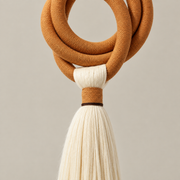 Macro of the coiled ring and the bound tassel head, terracotta ring and long tassel