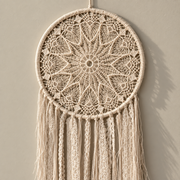 Macro of the cream mandala showing the crochet rings, hoop, moon or eye triangle