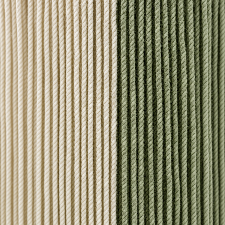 Close-up of two vertically ribbed fabric or cord textures side by side, one in warm cream/beige and one in muted sage green.
