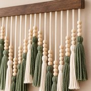 Close view of beaded cords and green and cream combed tassels under the batten