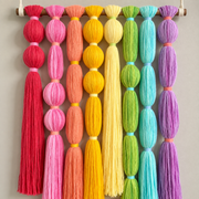 Macro of the wrapped beads and their contrast collars, rainbow tassel wall hanging