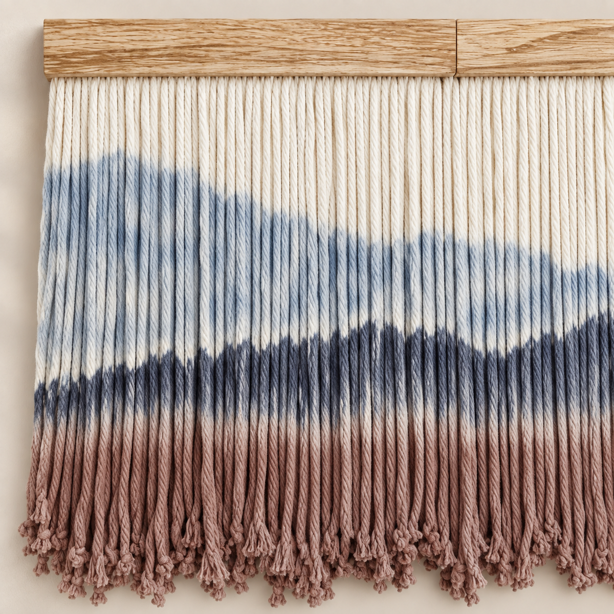 Close view of dip dyed cord bands and the small knotted tassels at the hem