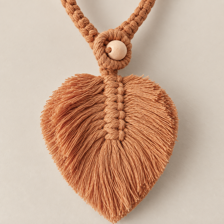 Macro of the brown leaf, its knot spine and the wooden bead, macrame leaf holdbacks in 6 colors