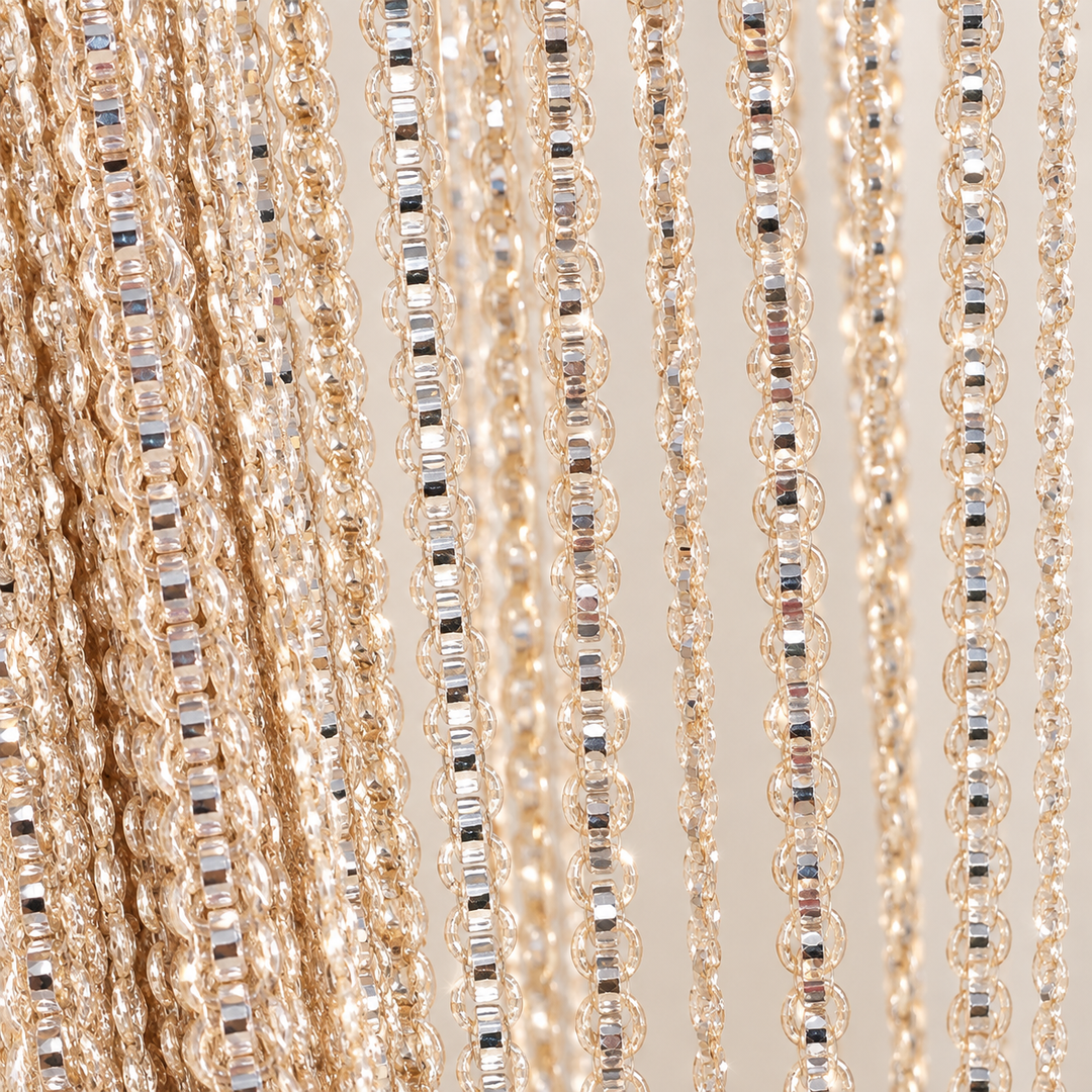 Orange strands held in a hand, shimmer string door curtain, polyester fiber with a metallic thread, per the supplier's own