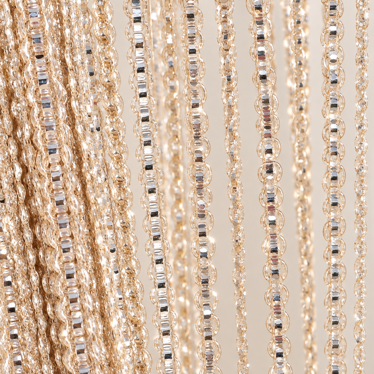 Orange strands held in a hand, shimmer string door curtain, polyester fiber with a metallic thread, per the supplier's own