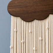 Macro of the cloud edge and the knotted cream cords, rain cord in 4 colors