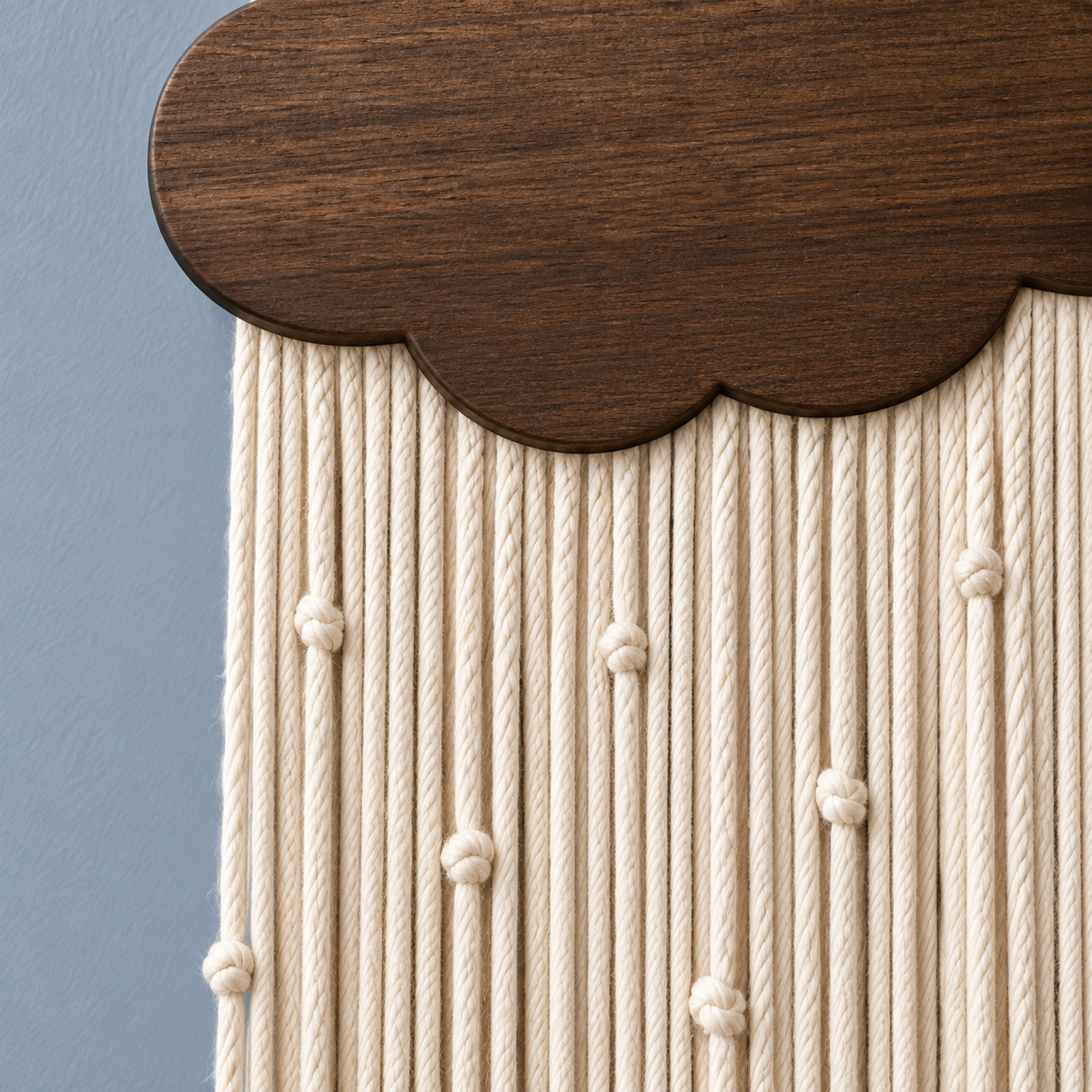 Macro of the cloud edge and the knotted cream cords, rain cord in 4 colors