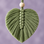 Close view of a single sage macrame leaf and its pale wooden bead on the dropper cord