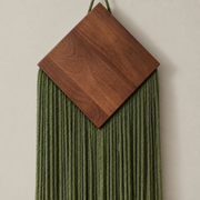 Macro of the wood diamond meeting the green fringe, wood diamond over a narrow chevron fringe